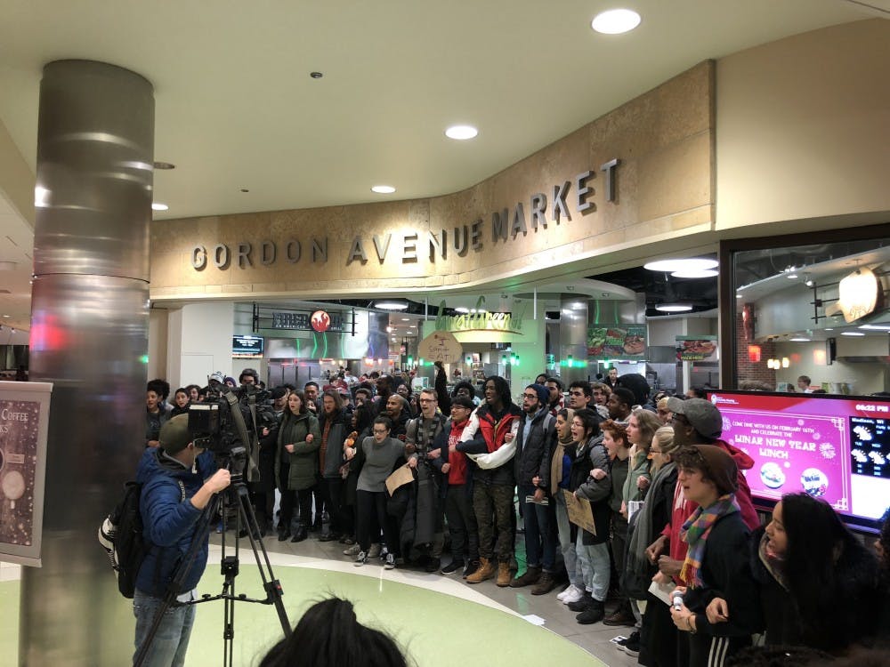 About 100 UW-Madison community members gathered in Gordon Tuesday to protest the university's meal plan.