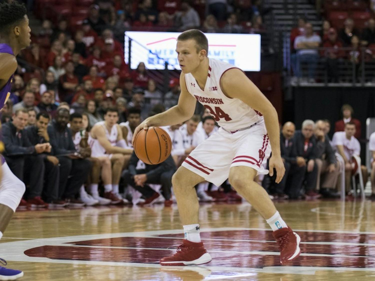 Brad Davison drew a blocking foul with two seconds to play in regulation and split a crucial pair of free throws to give UW a 81-80 victory. 