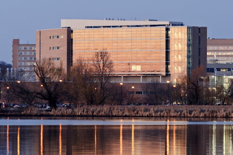 Rennebohm Hall is reflected in the still water of Lake Mendota along the University of Wisconsin-Madison shoreline during dawn on March 13, 2012. The view was made from Picnic Point, an area that is part of UW-Madison's Lakeshore Nature Preserve. (Photo by Jeff Miller/UW-Madison)