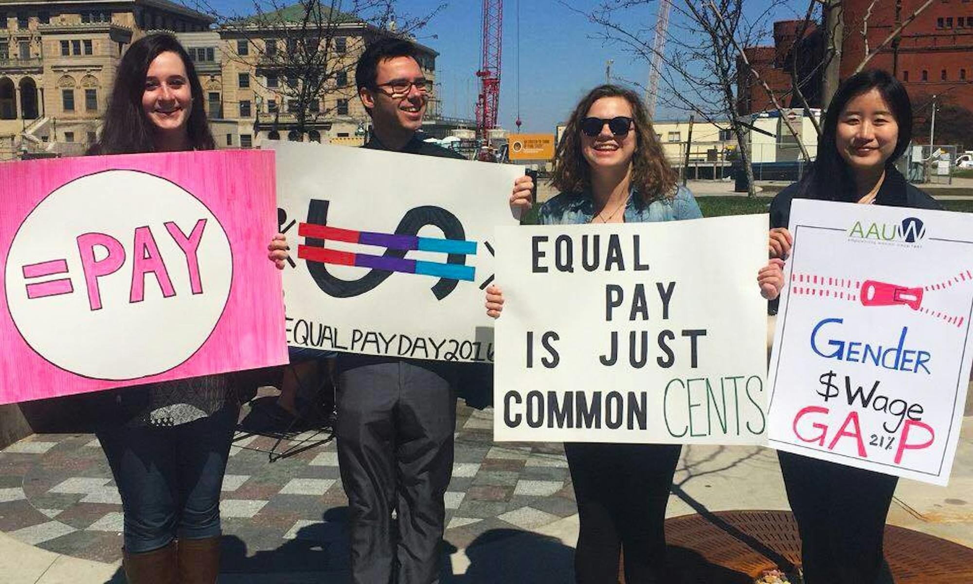 Students on Library Mall held signs and passed out buttons to spread awareness about gender inequalities in the workforce.