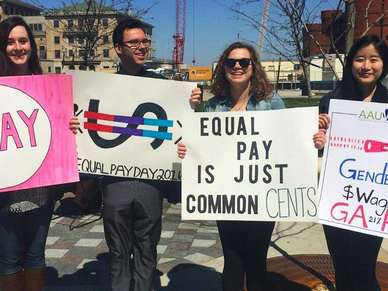 Students on Library Mall held signs and passed out buttons to spread awareness about gender inequalities in the workforce.