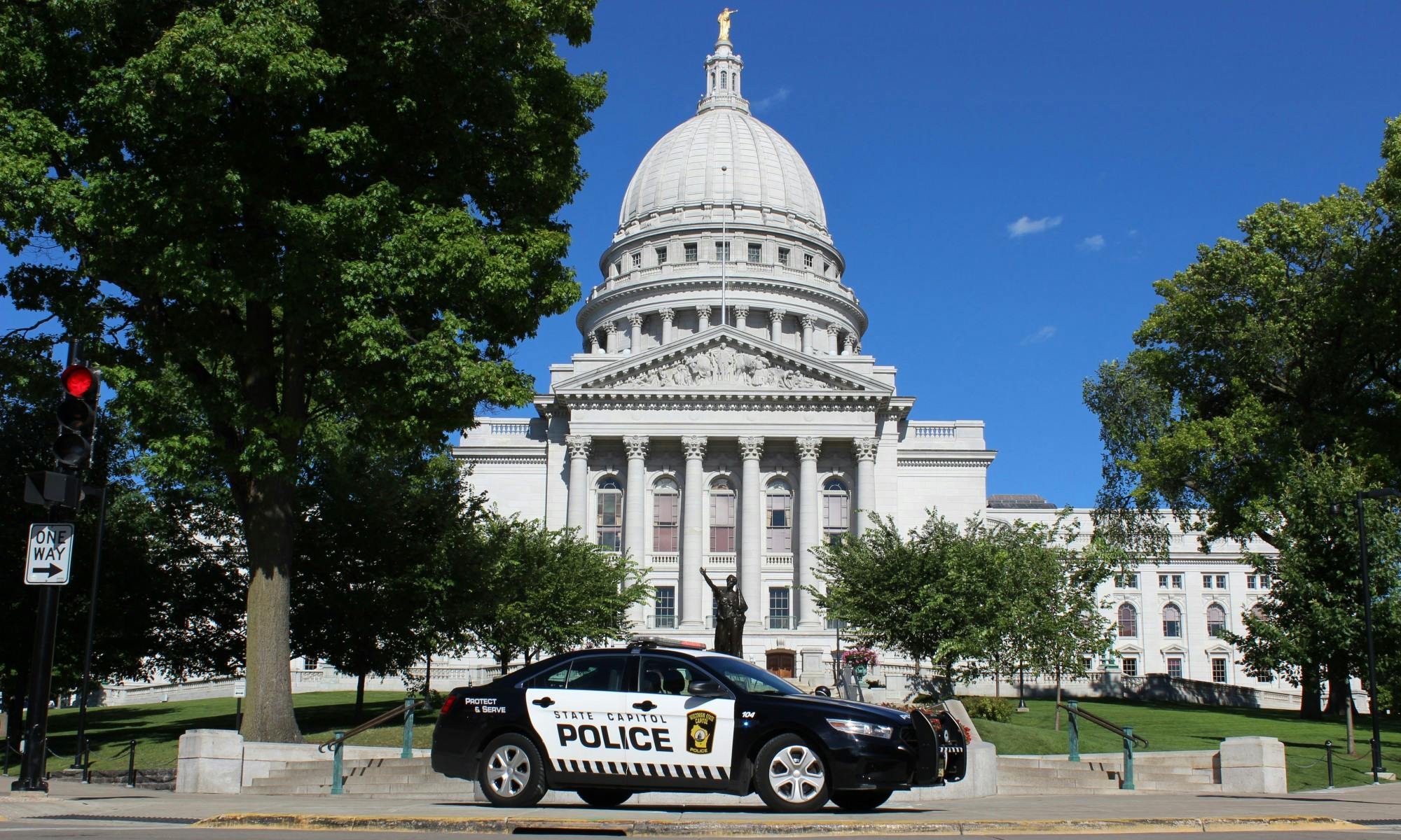 Photo of a State Capitol Police car in front of the Wisconsin State Capitol.