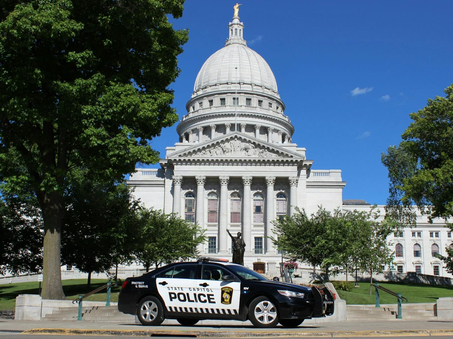 Photo of a State Capitol Police car in front of the Wisconsin State Capitol.