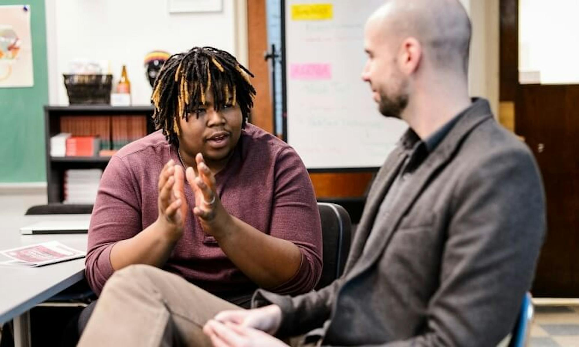 Great Texts program coordinator Manuel Herrero-Puertas speaks with a student at New Horizons Charter School.