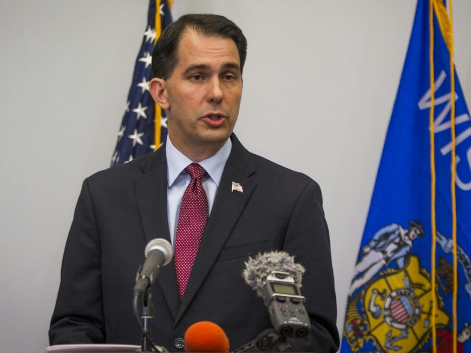 Gov. Scott Walker signed almost 60 bills into law Tuesday, including one making it easier for law enforcement to perform strip searches.