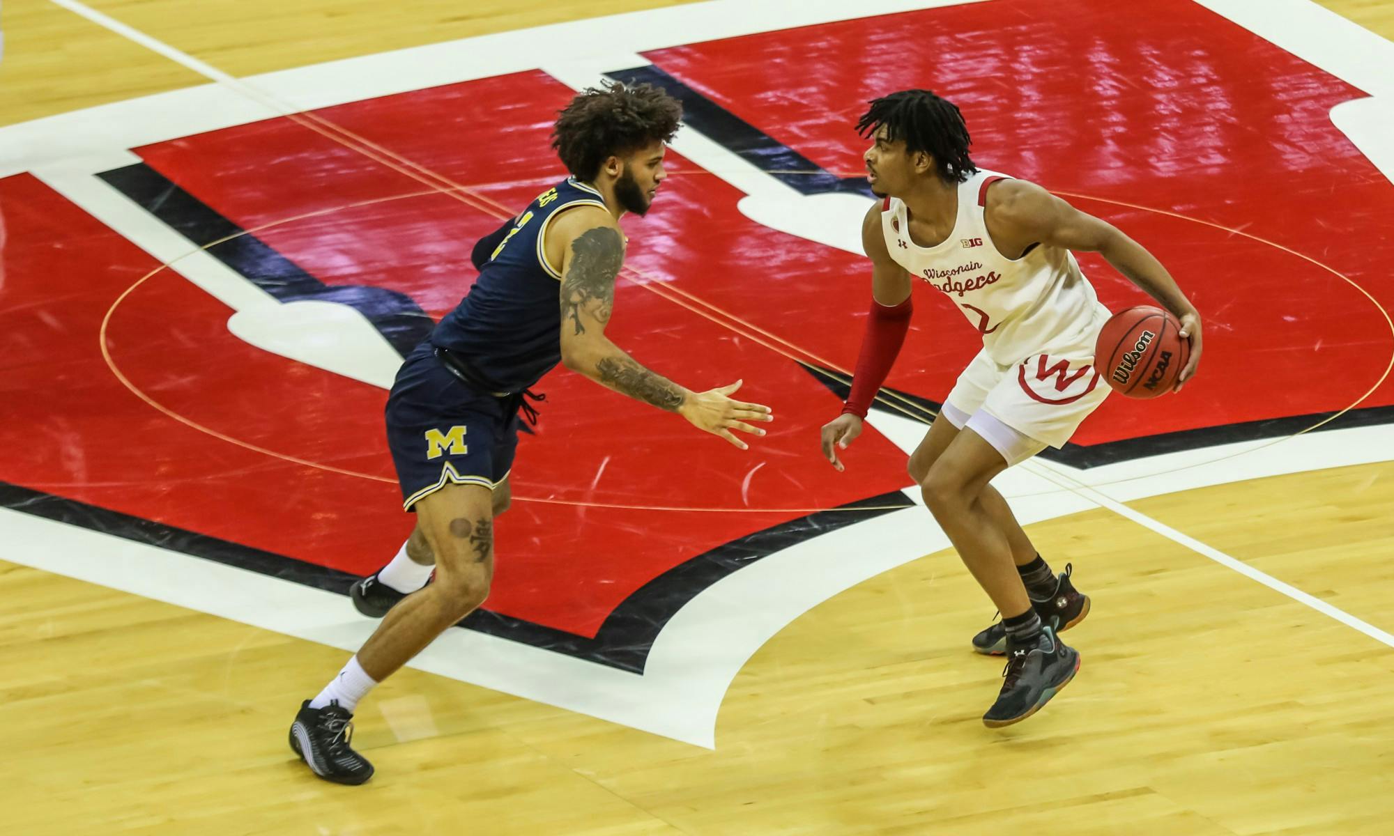 Photo of Aleem Ford dribbling across half court in a home game versus Michigan.