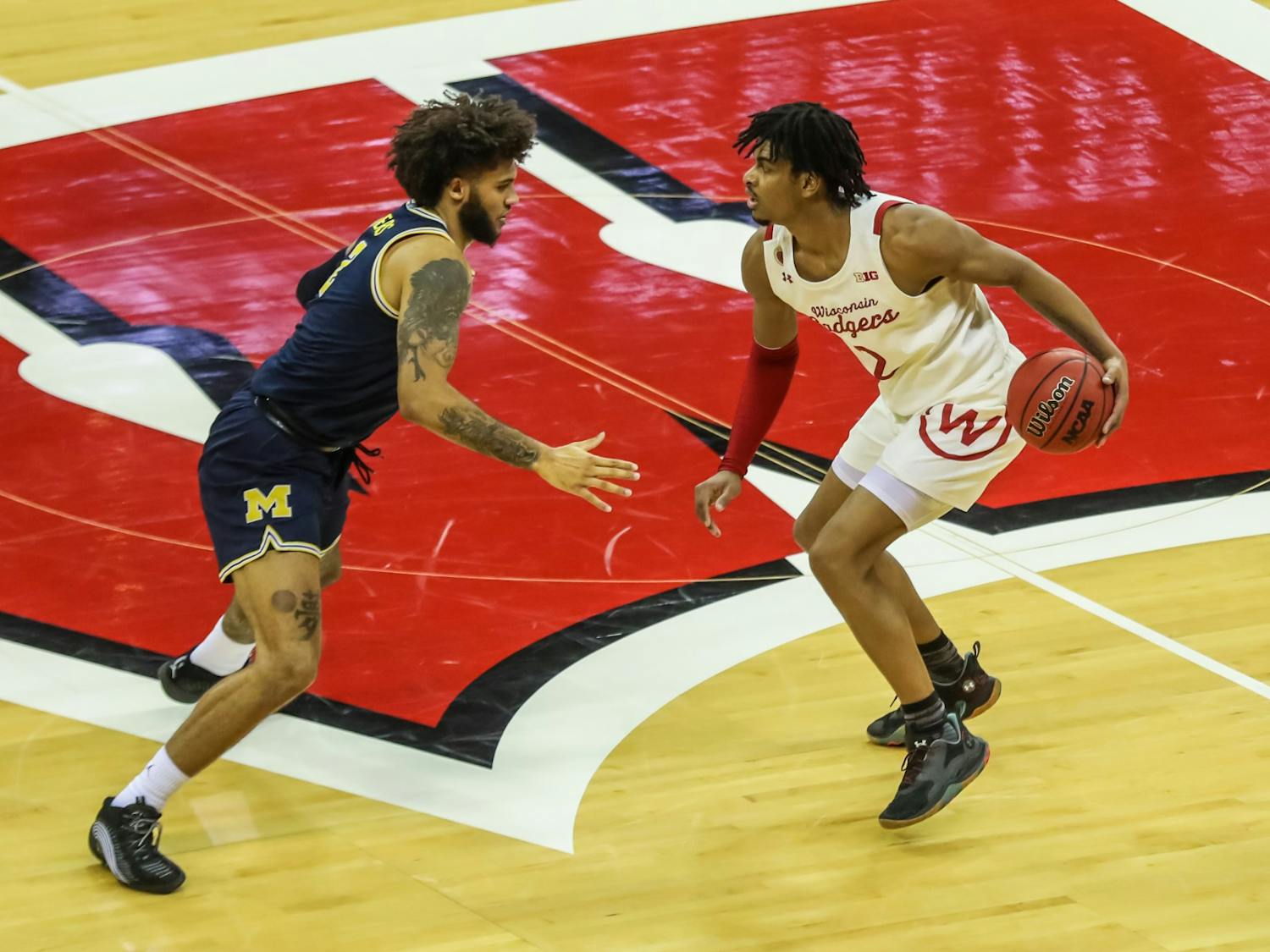 Photo of Aleem Ford dribbling across half court in a home game versus Michigan.
