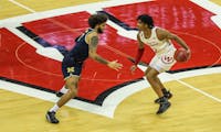Photo of Aleem Ford dribbling across half court in a home game versus Michigan.