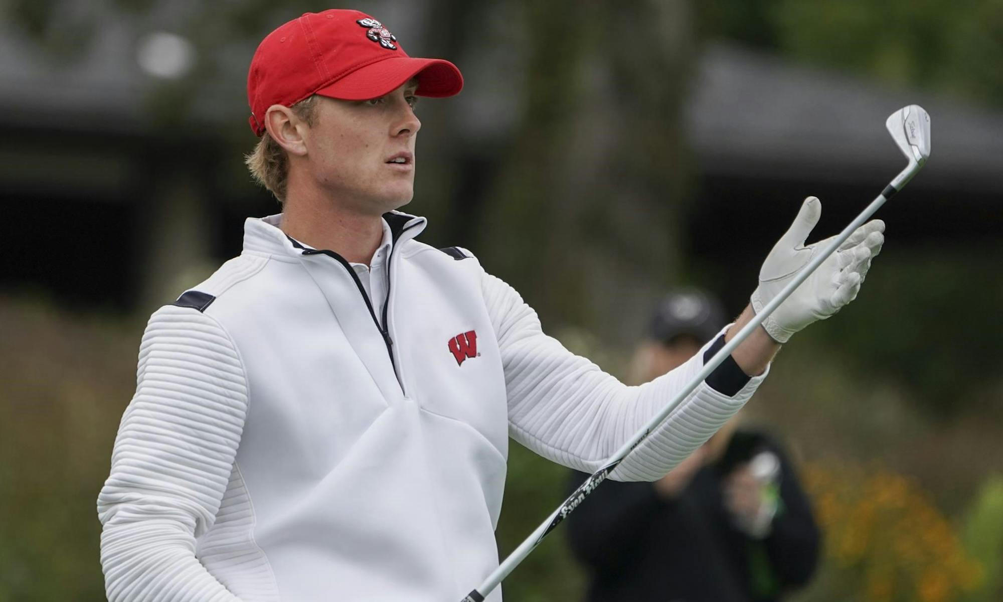 Photo of a UW- Madison golfer after his swing.