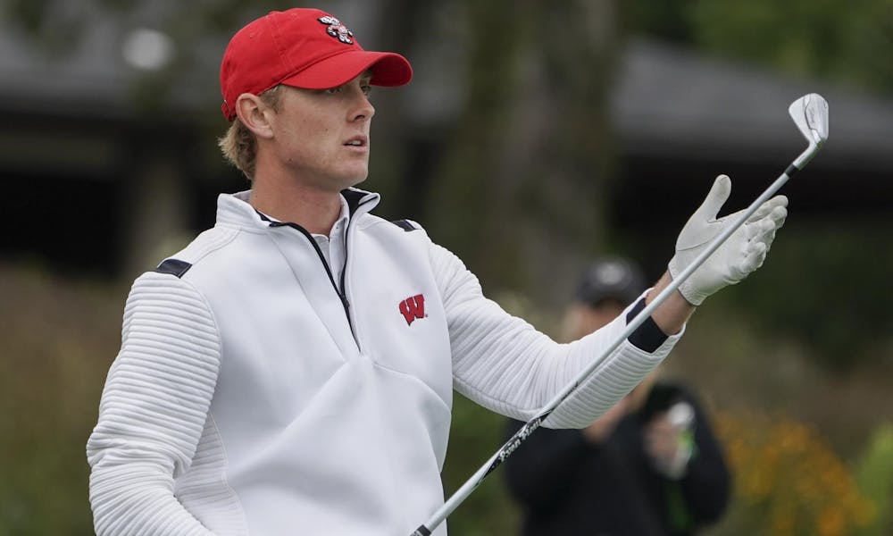 Photo of a UW- Madison golfer after his swing.