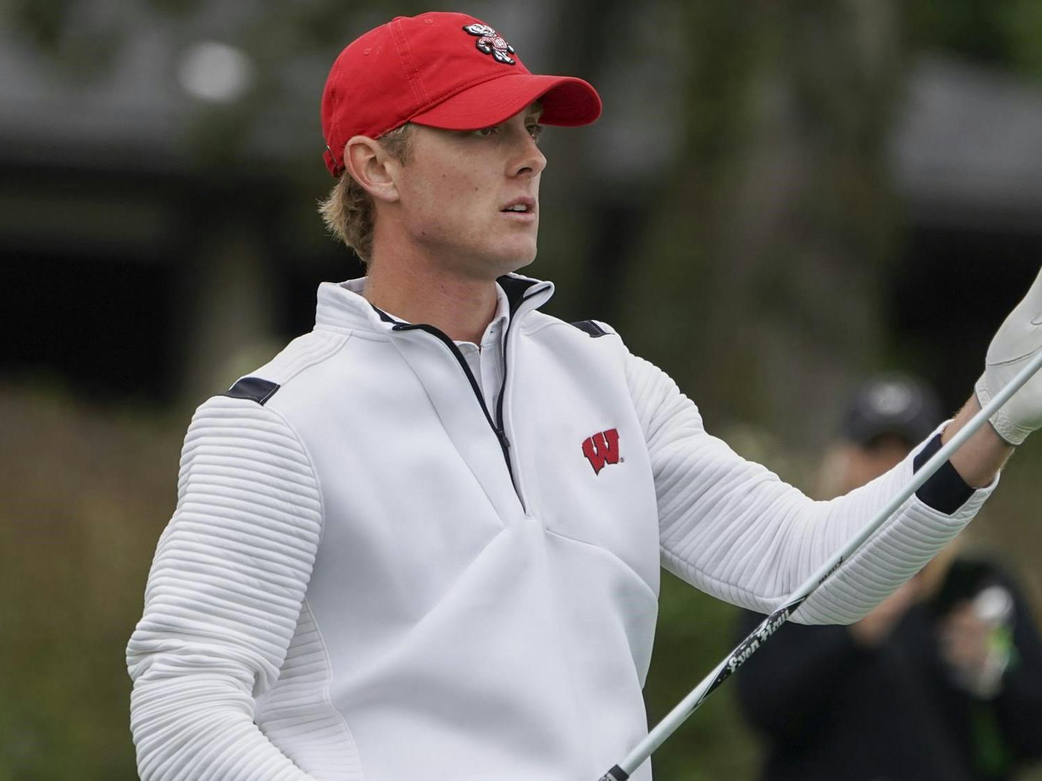 Photo of a UW- Madison golfer after his swing.
