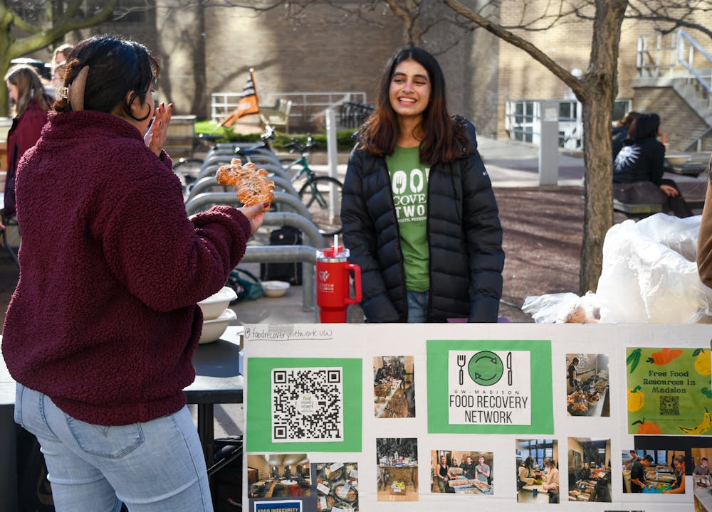A member of Slow Food UW talks with a member of the Student Voters Union at ASM Sustainability's March Forth to Earth Day event on April 5, 2024.