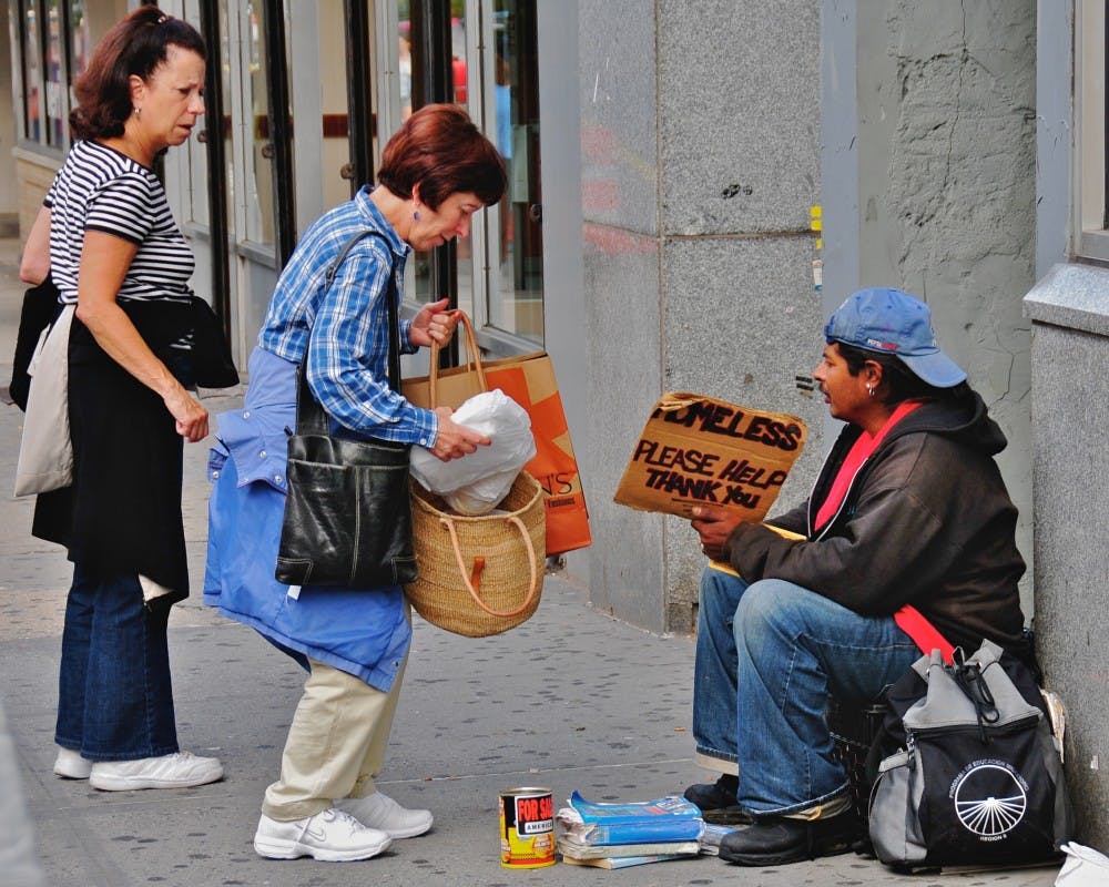 This was taken about halfway up the block on the east side of Broadway, between 79th and 80th Street. It's at the north end of the "Filene's Basement" store on the corner, and it's a place where I've often seen homeless people holding up a sign that asks for assistance...With very rare exceptions, I haven't photographed these homeless people; it seems to me that they're in a very defensive situation, and I don't want to take advantage of their situation. But something unusual was happening here: the two women (who were actually cooperating, and acting in tandem, despite the rather negative demeanor of the woman on the left) were giving several parcels of food to the young homeless man on the right.I don't know if the women were bringing food from their own kitchen, or whether they had brought it from a nearby restaurant. But it was obviously a conscious, deliberate activity, and one they had thousght about for some time...What was particularly interesting was that they didn't dwell, didn't try to have a conversation with the young man;they gave him they food they had brought, and promptly walked away. As they left, I noticed the young man peering into his bag (the one you see on the ground beside him in this picture) to get a better sense of the delicious meal these two kind women had brought him...**********************This is part of an evolving photo-project, which will probably continue throughout the summer of 2008, and perhaps beyond: a random collection of "interesting" people in a broad stretch of the Upper West Side of Manhattan -- between 72nd Street and 104th Street, especially along Broadway and Amsterdam Avenue.I don't like to intrude on people's privacy, so I normally use a telephoto lens in order to photograph them while they're still 50-100 feet away from me; but that means I have to continue focusing my attention on the people and activities half a block away, rather than on what's right in front of me.I've also learned that, in many c