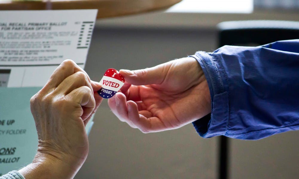 A legislative committee voted to extend an emergency voter ID rule, despite debate over whether voters have been told conflicting information regarding the law.