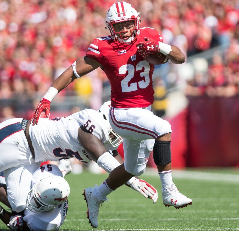 Jonathan Taylor had a historic day, leading Wisconsin to victory with 223 yards rushing and three touchdowns.