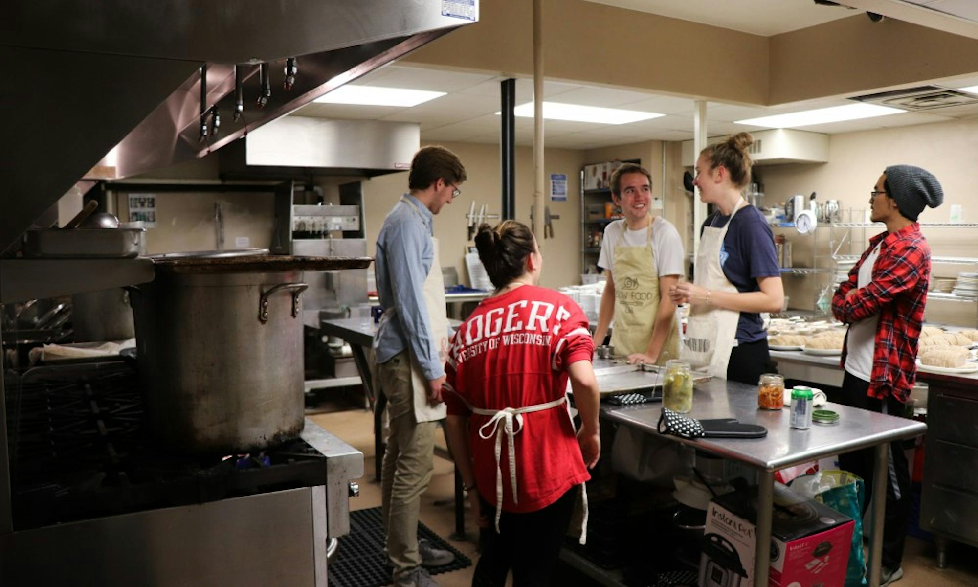 Slow food volunteers prepare a meal in the basement of the crossing. They see themselves as resources,&nbsp;not solutions to food insecurity.