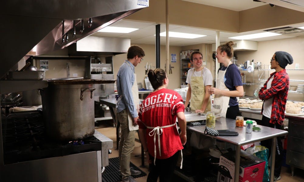 Slow food volunteers prepare a meal in the basement of the crossing. They see themselves as resources,&nbsp;not solutions to food insecurity.