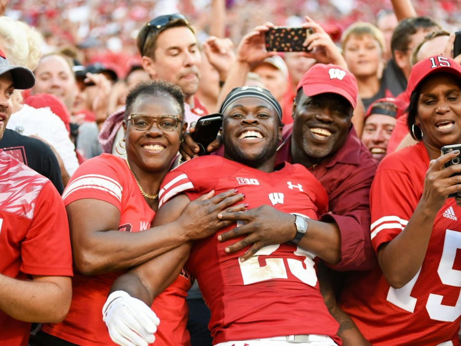 Ogunbowale with his family after the Badgers knocked off LSU at Lambeau Field. 