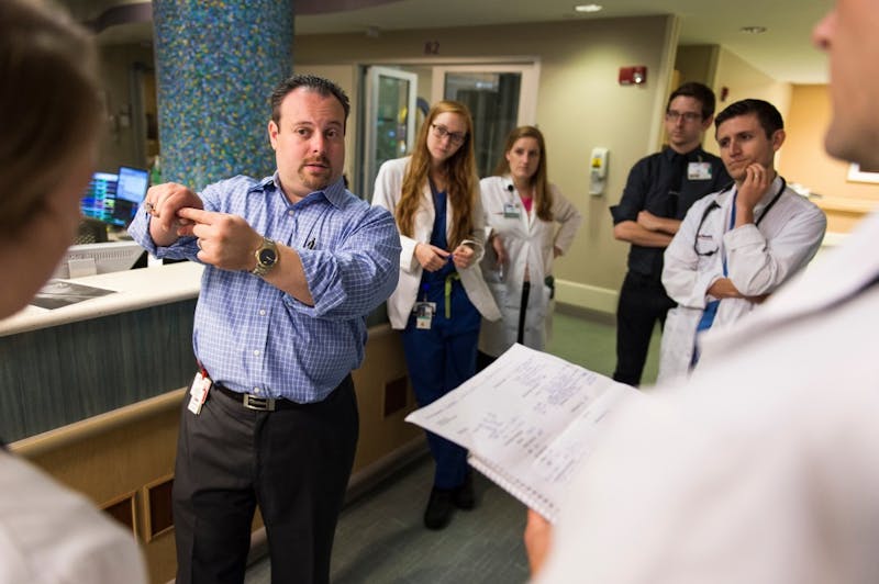 Josh Medow, left, medical director of the Neurocritical Intensive Care Unit at UW Hospital and Clinics, discusses a patient