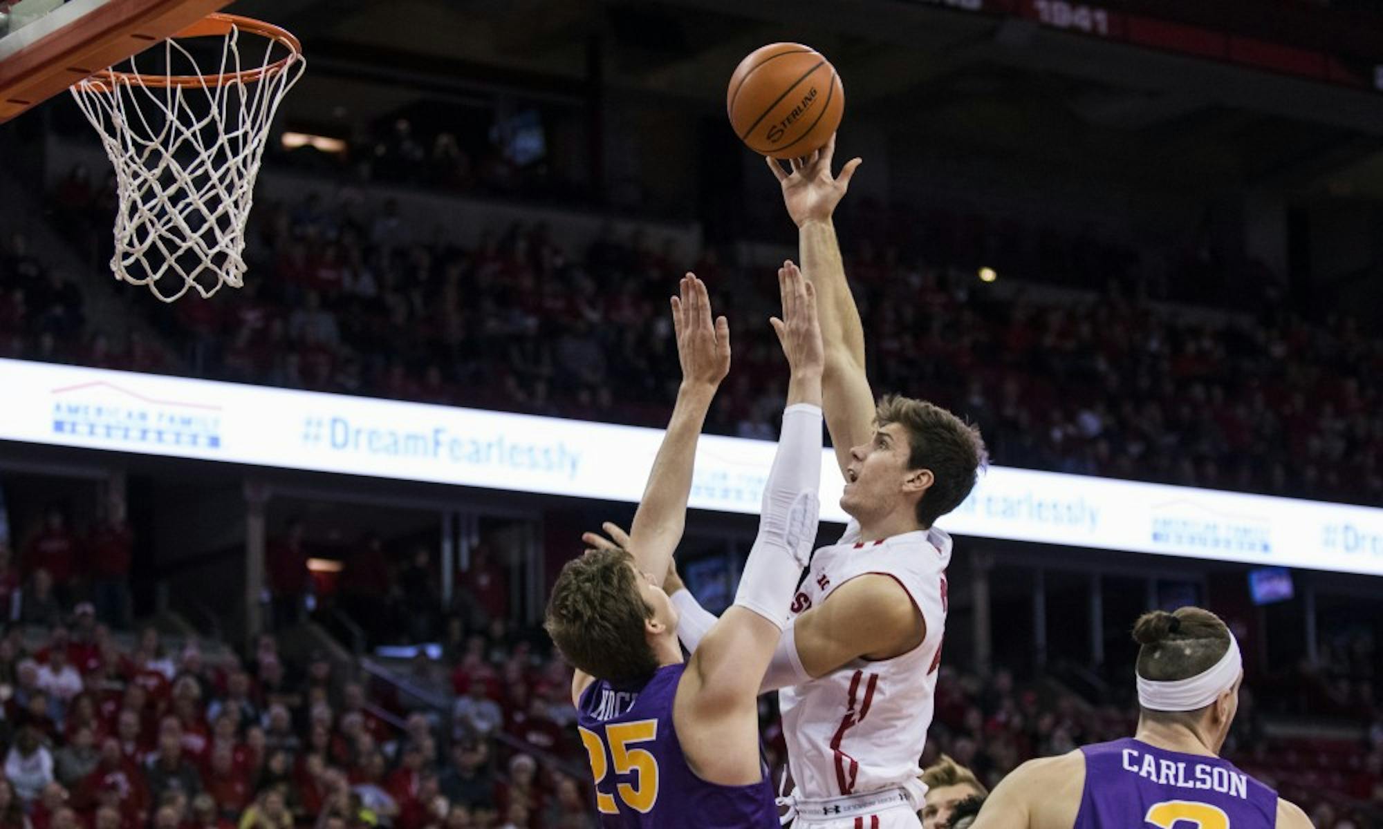 Ethan Happ scored a game-high 22 points and added a season-high 15 rebounds as Wisconsin fell to No. 4 Virginia.