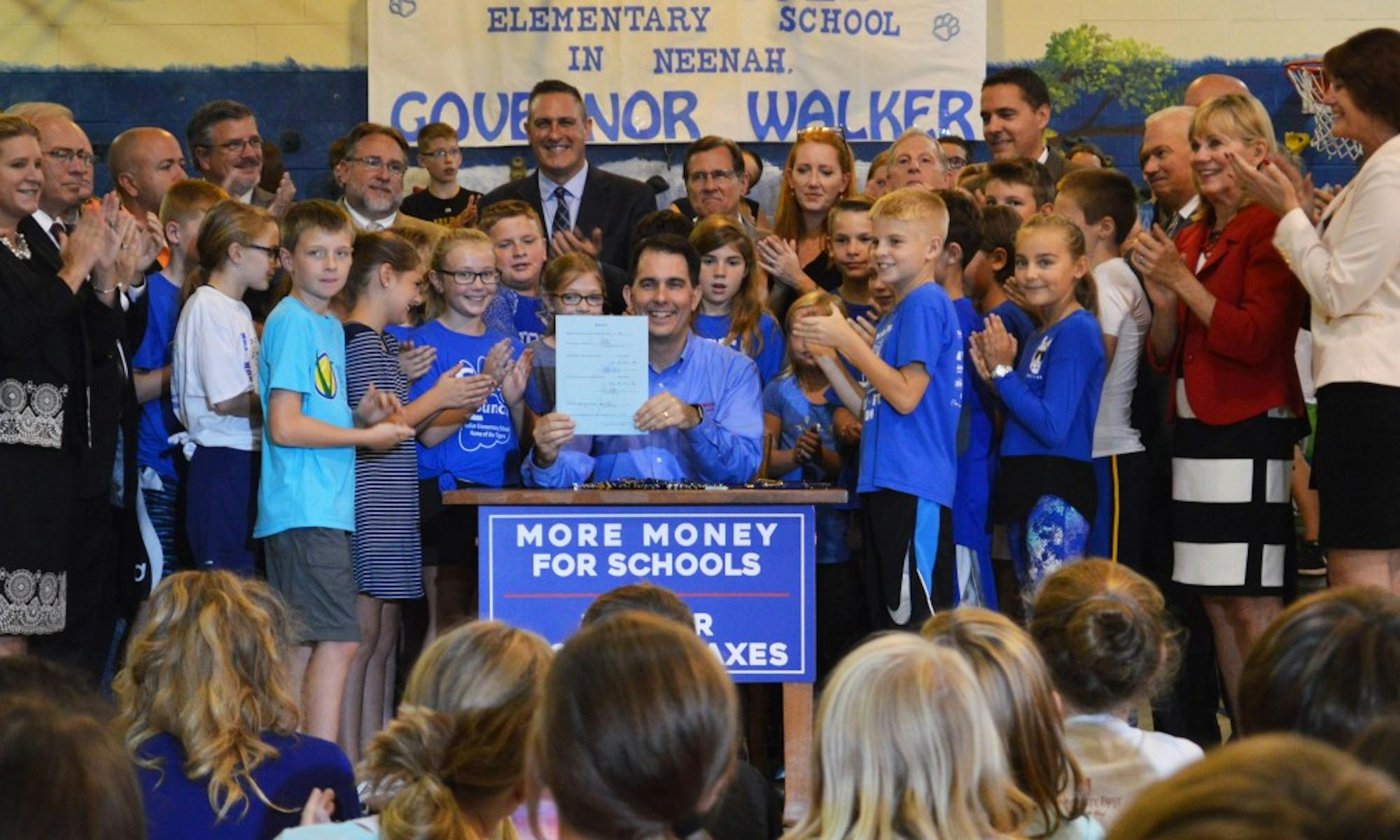 Gov. Scott Walker officially signed the 2017-’19 budget into effect Thursday at Tullar Elementary School in Neenah.