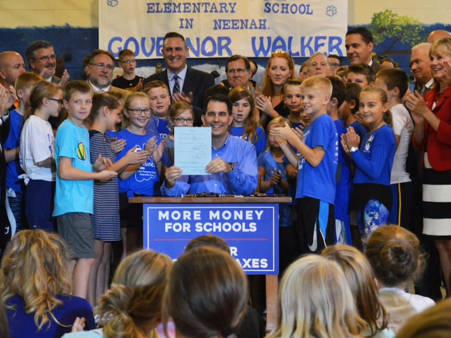 Gov. Scott Walker officially signed the 2017-’19 budget into effect Thursday at Tullar Elementary School in Neenah.