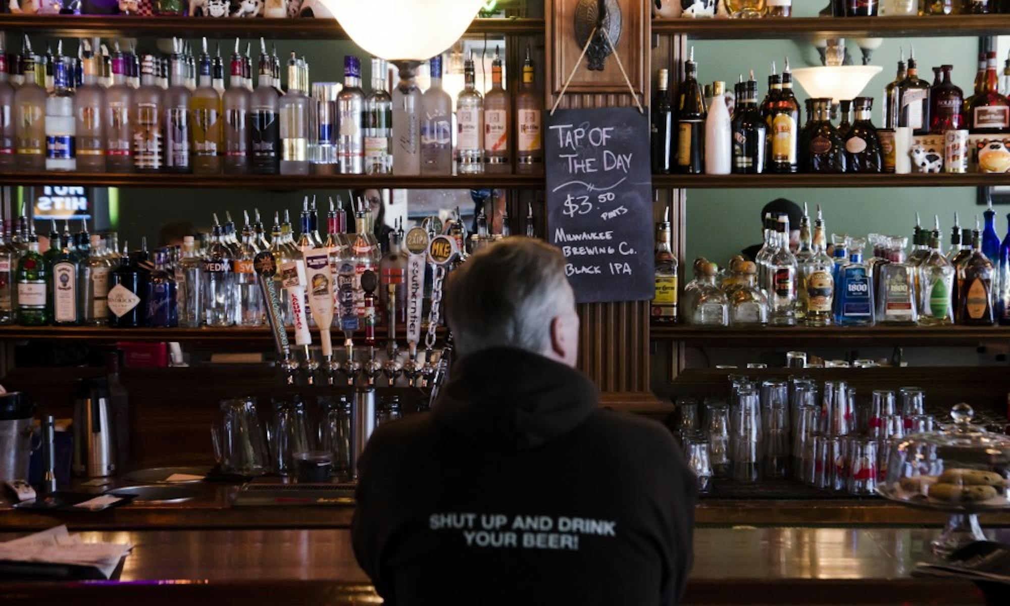 Ray Blando, local bar owner, staring at his rows of alcohol and listening to something that’s not hip-hop.