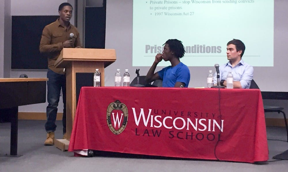 Reggie Thedford discussed the importance of community awareness of prison conditions while fellow panelists Tyriek Mack and Michael Roy look on during a panel on mass incarceration at the Law School.