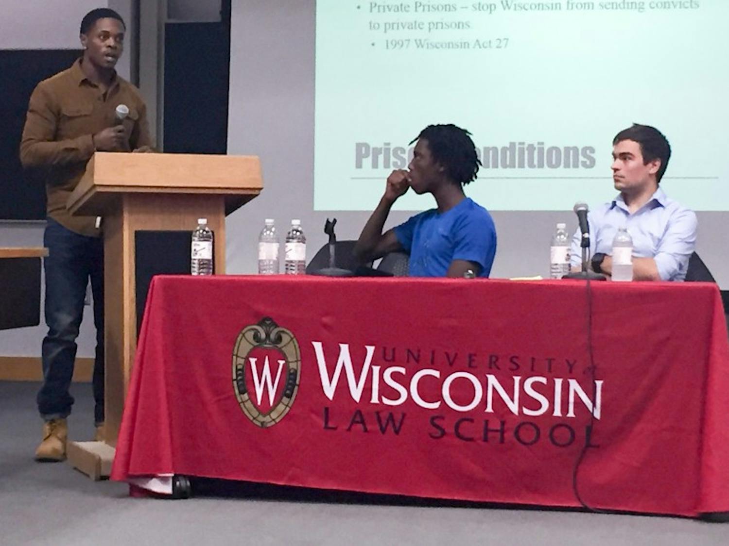 Reggie Thedford discussed the importance of community awareness of prison conditions while fellow panelists Tyriek Mack and Michael Roy look on during a panel on mass incarceration at the Law School.