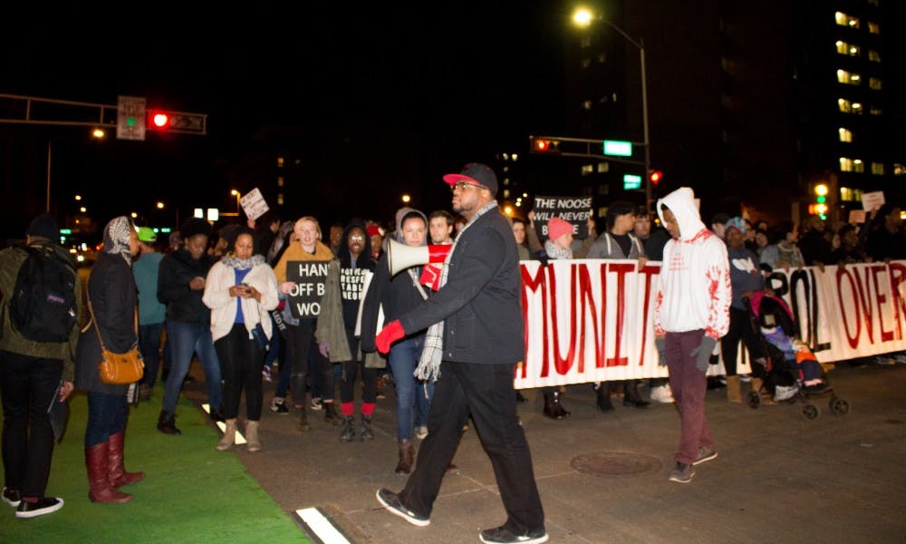 UW-Madison students Michael Davis, Eneale Pickett and&nbsp;other protesters&nbsp;halted traffic Friday to&nbsp;demand community control of the school system and police forces.