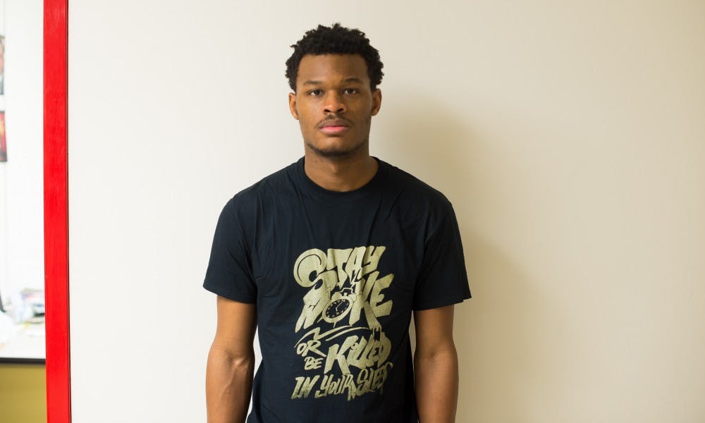 UW-Madison sophomore Eneale Pickett strives to spark conversations through his apparel, which he models above, from his line “Resistance: Gold Edition.”