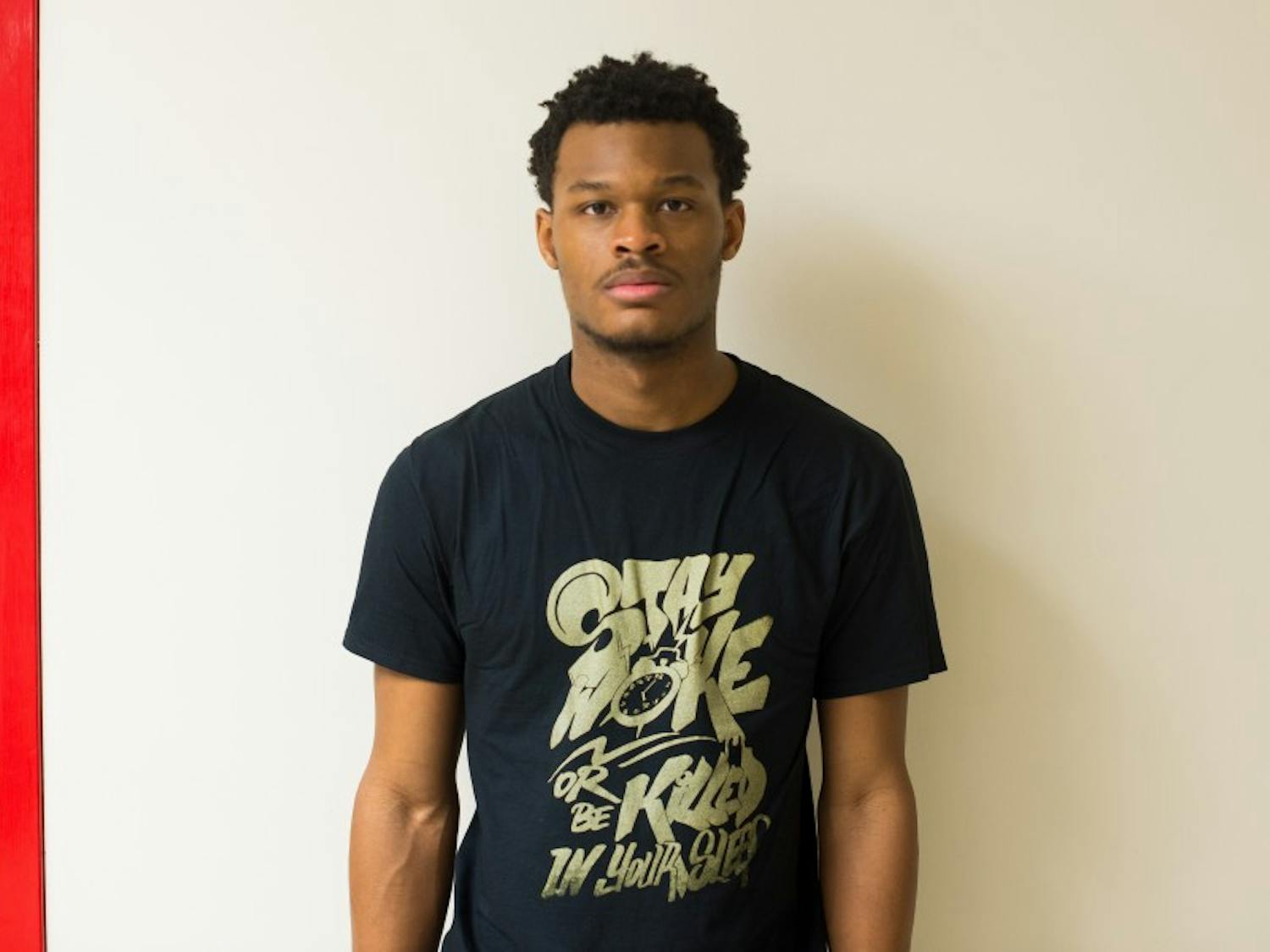 UW-Madison sophomore Eneale Pickett strives to spark conversations through his apparel, which he models above, from his line “Resistance: Gold Edition.”