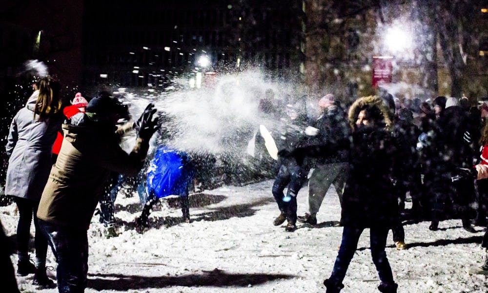 Current and former residents of the Lakeshore and Southeast neighborhoods faced off on Bascom Hill in the annual Battle for Bascom snowball fight.
