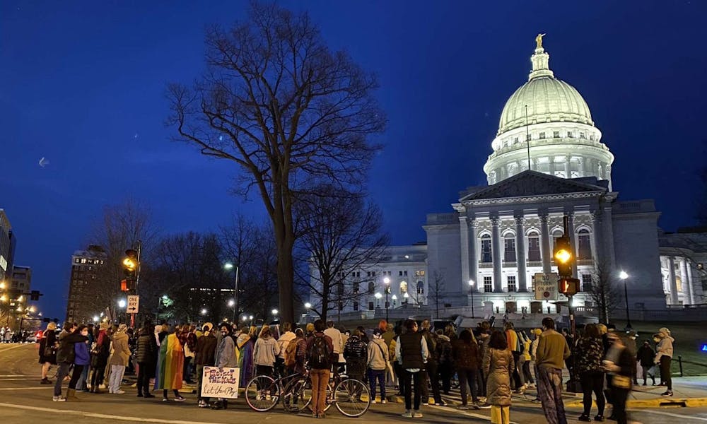 Photo of a protest in front of the Wisconsin State Capitol in support of trans athletes.