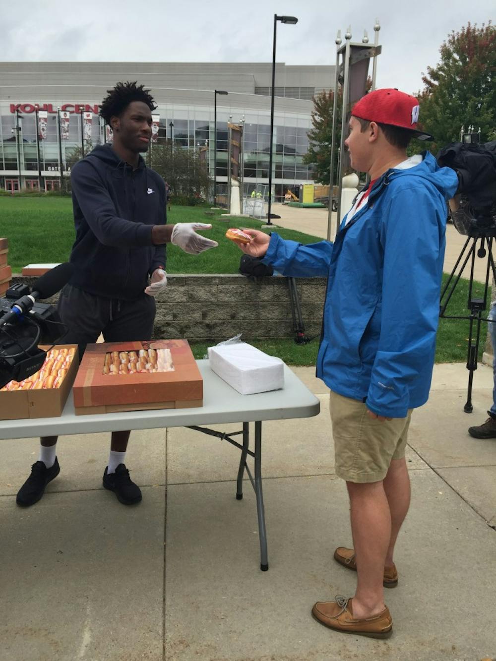 Nigel Hayes handing&nbsp;out the first of many doughnuts Friday.&nbsp;