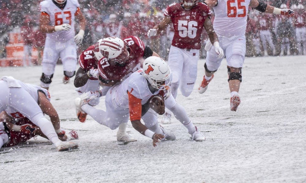 Wisconsin's defense took advantage of a sudden snowstorm late in the first quarter to collect three interceptions and a pair of fumbles in the first half.