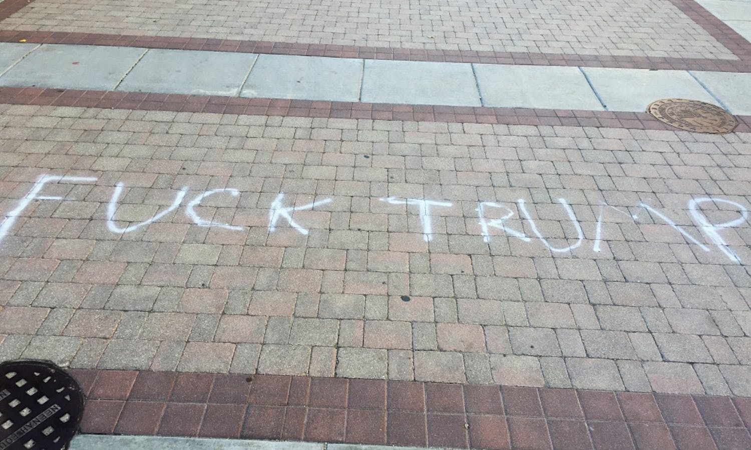 Two phrases, one reading “Fuck Trump” and the other “Black Lives Matter,” were spray-painted on East Campus Mall Wednesday.