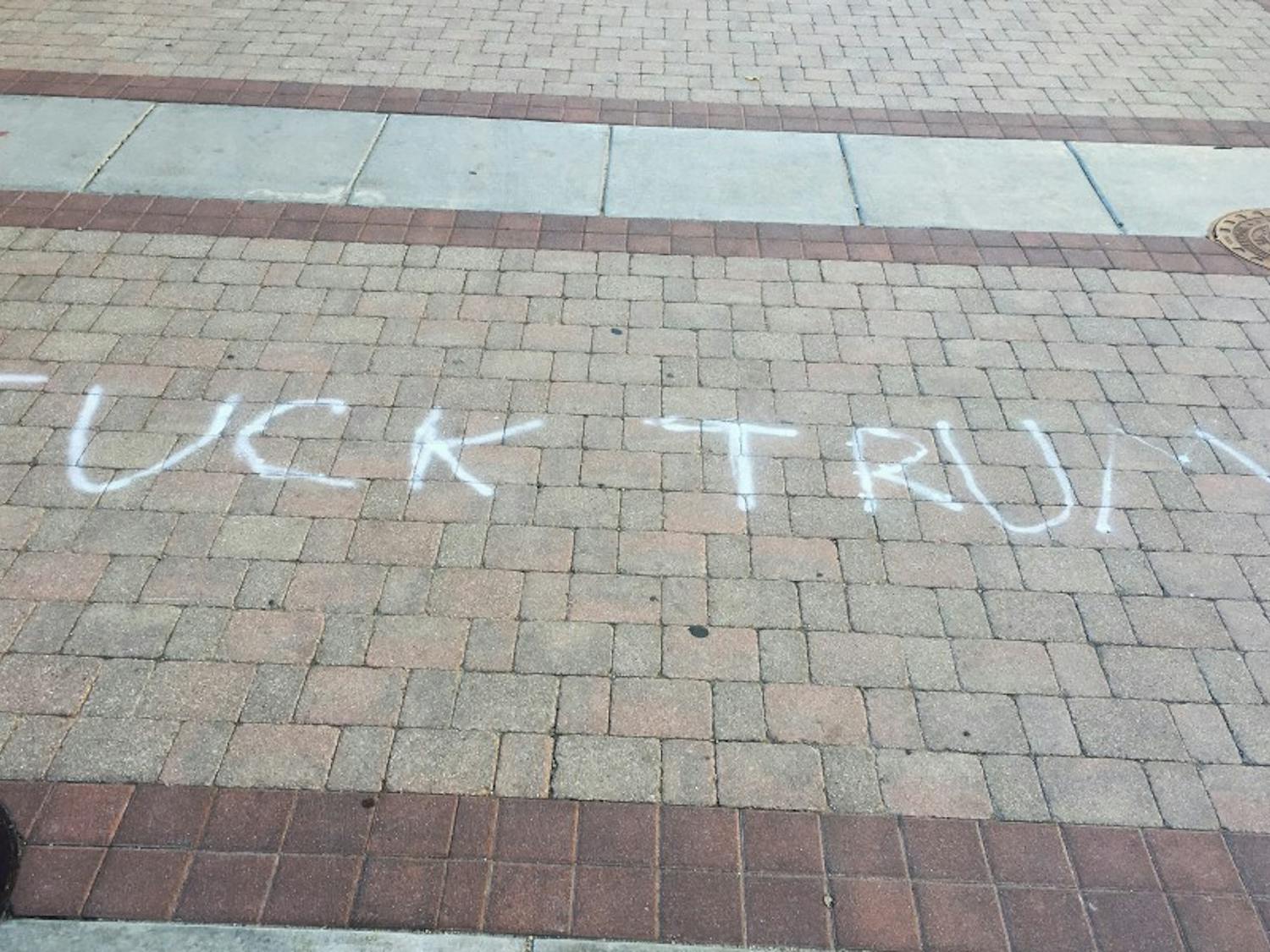 Two phrases, one reading “Fuck Trump” and the other “Black Lives Matter,” were spray-painted on East Campus Mall Wednesday.