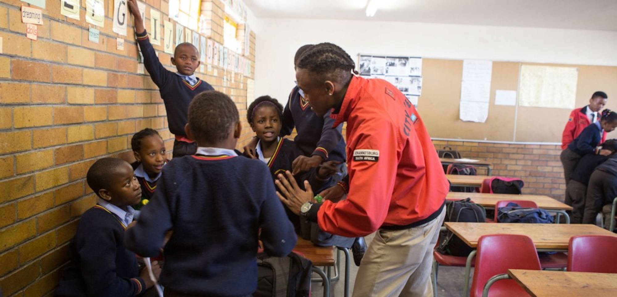 City Year members spend time with children supplementing after-school educational programs in the U.S. and abroad.