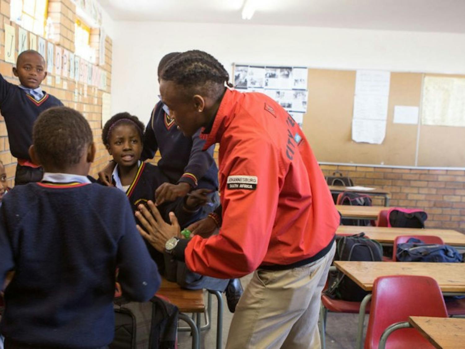 City Year members spend time with children supplementing after-school educational programs in the U.S. and abroad.