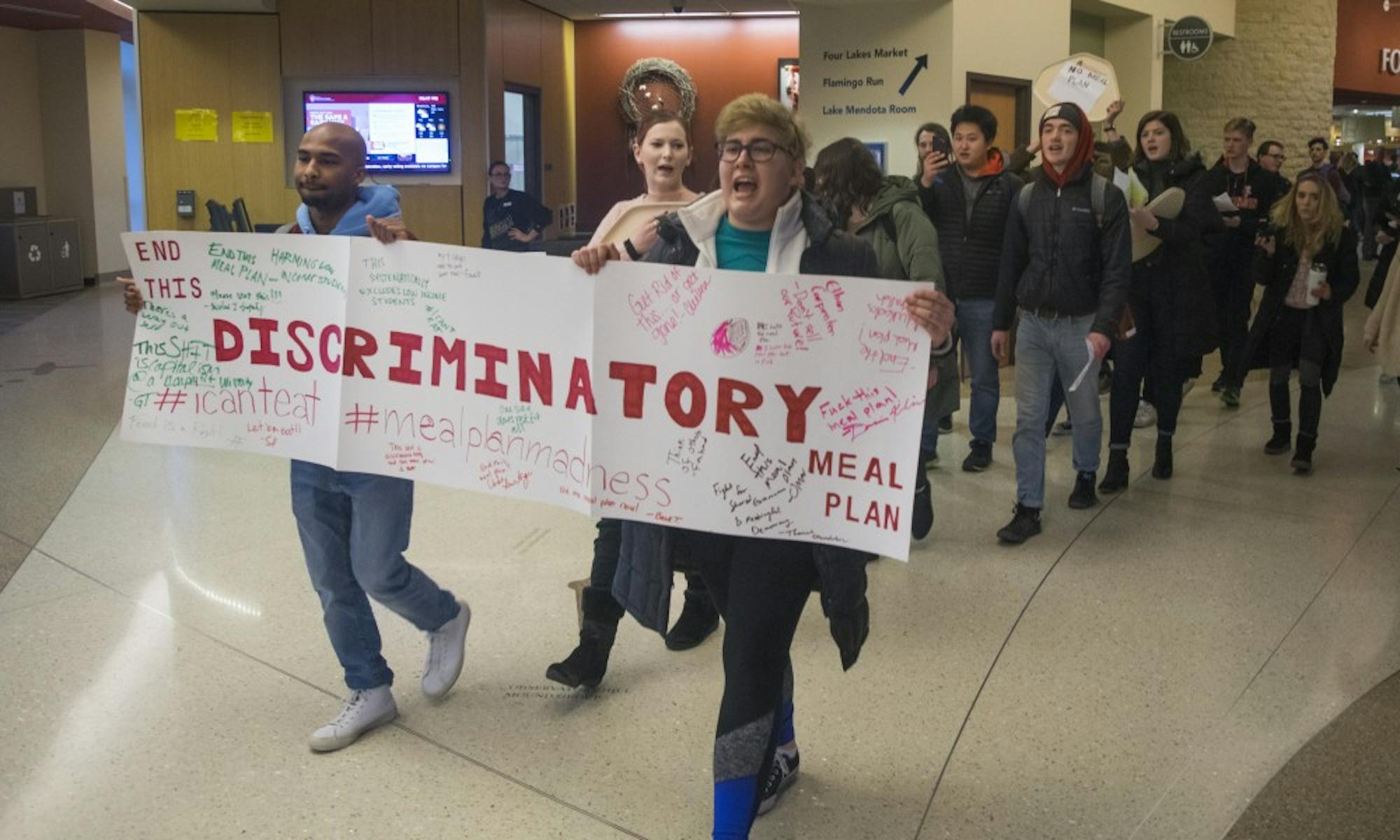 Students marched through Four Lakes Market Tuesday to voice their opposition against UW-Madison's meal plan for incoming freshmen.&nbsp;