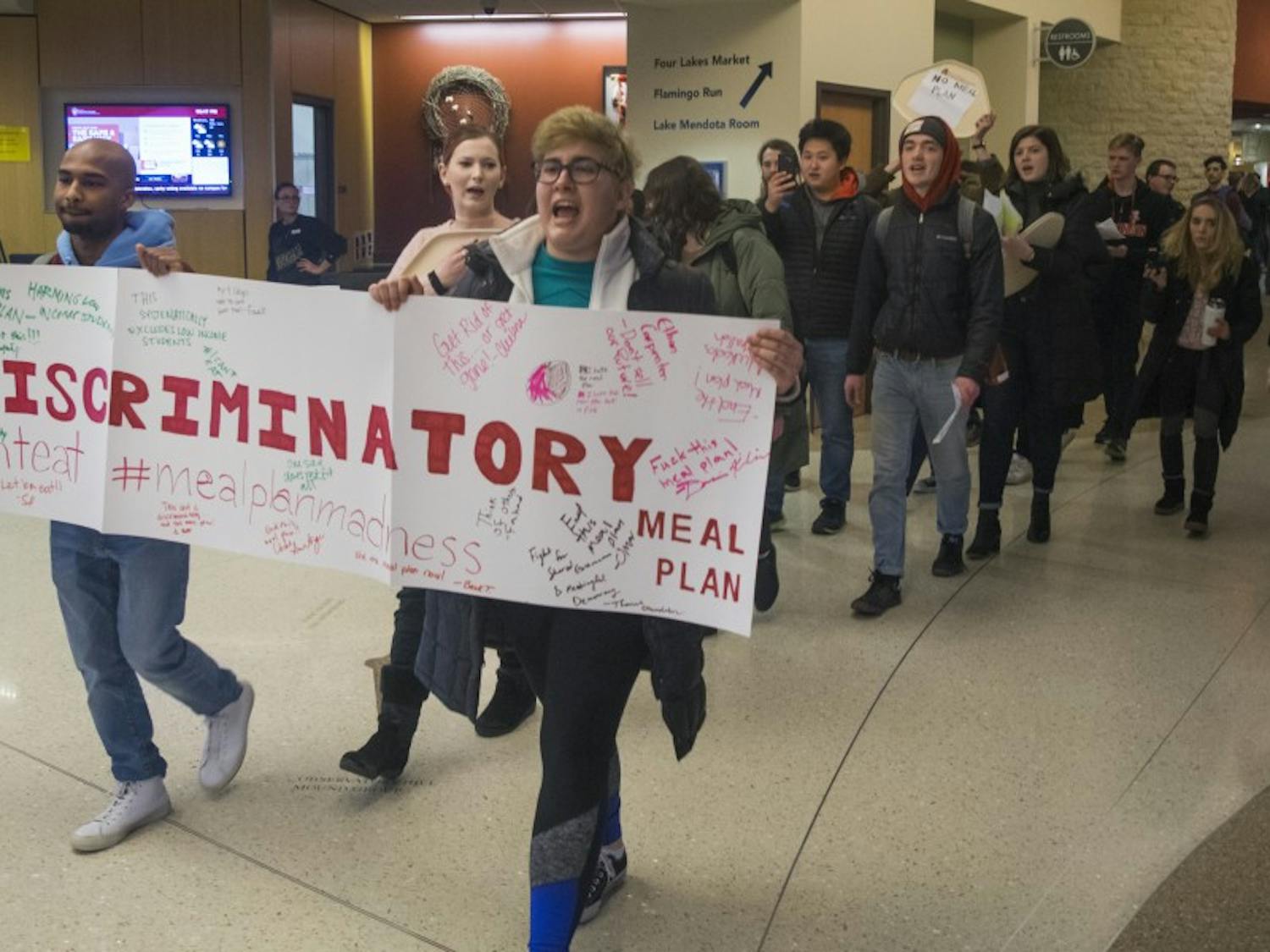 Students marched through Four Lakes Market Tuesday to voice their opposition against UW-Madison's meal plan for incoming freshmen.&nbsp;