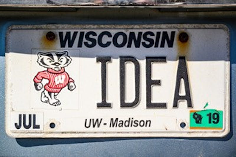 A personalized license plate displaying a nod to the Wisconsin Idea, a philosophy embraced by the University of Wisconsin System, is spotted on a vehicle in Lot 34 on April 23, 2019. (Photo by Bryce Richter /UW-Madison)