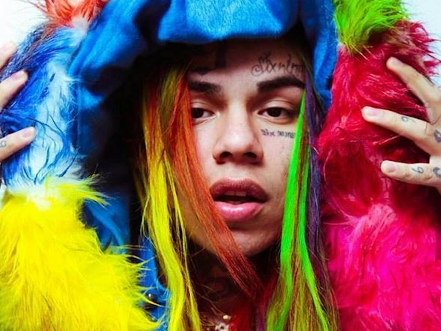Don't let the bright accents of his eccentric looks fool you &mdash; 6ix9ine has a dark history.