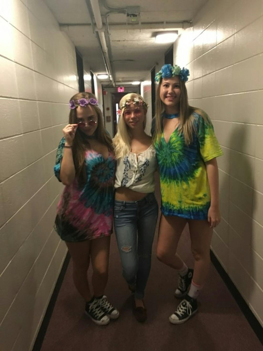 Three students show off their homemade hippie costumes.