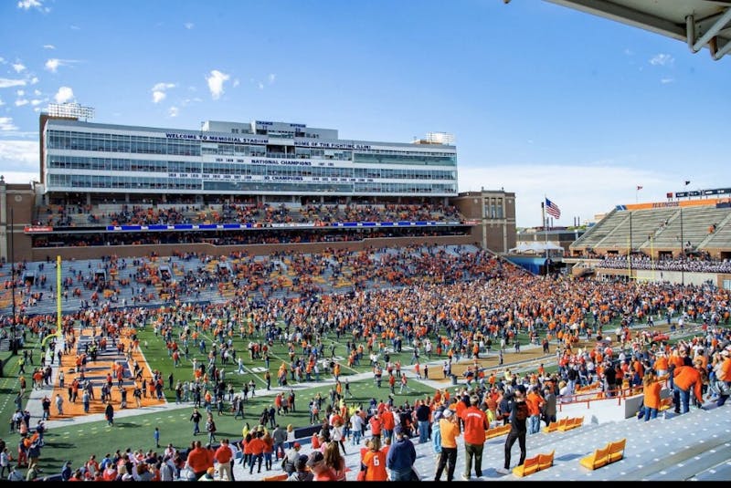 Illinois fans storm the field after pulling off massive upset on homecoming weekend. 