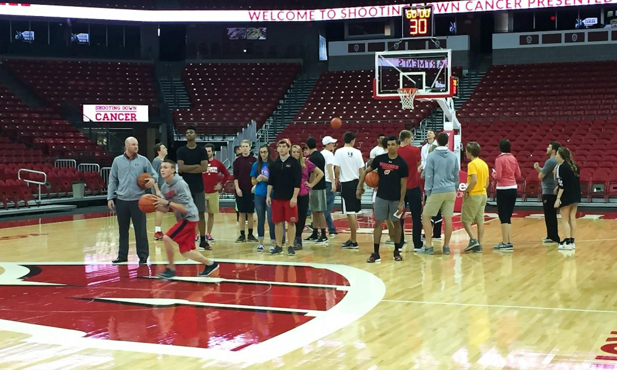 Wisconsin head coach Greg Gard and the rest of UW's men's basketball team teamed up with students to raise more than $20,000 for cancer research Monday afternoon.