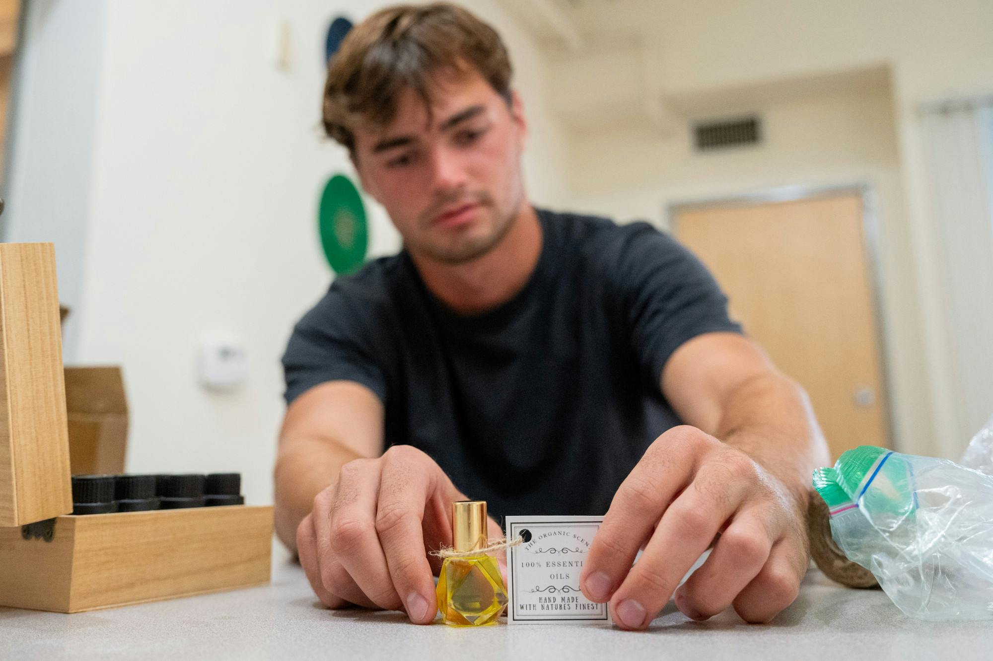 Matthew Zachemski takes the Cardinal through his cologne bottling process