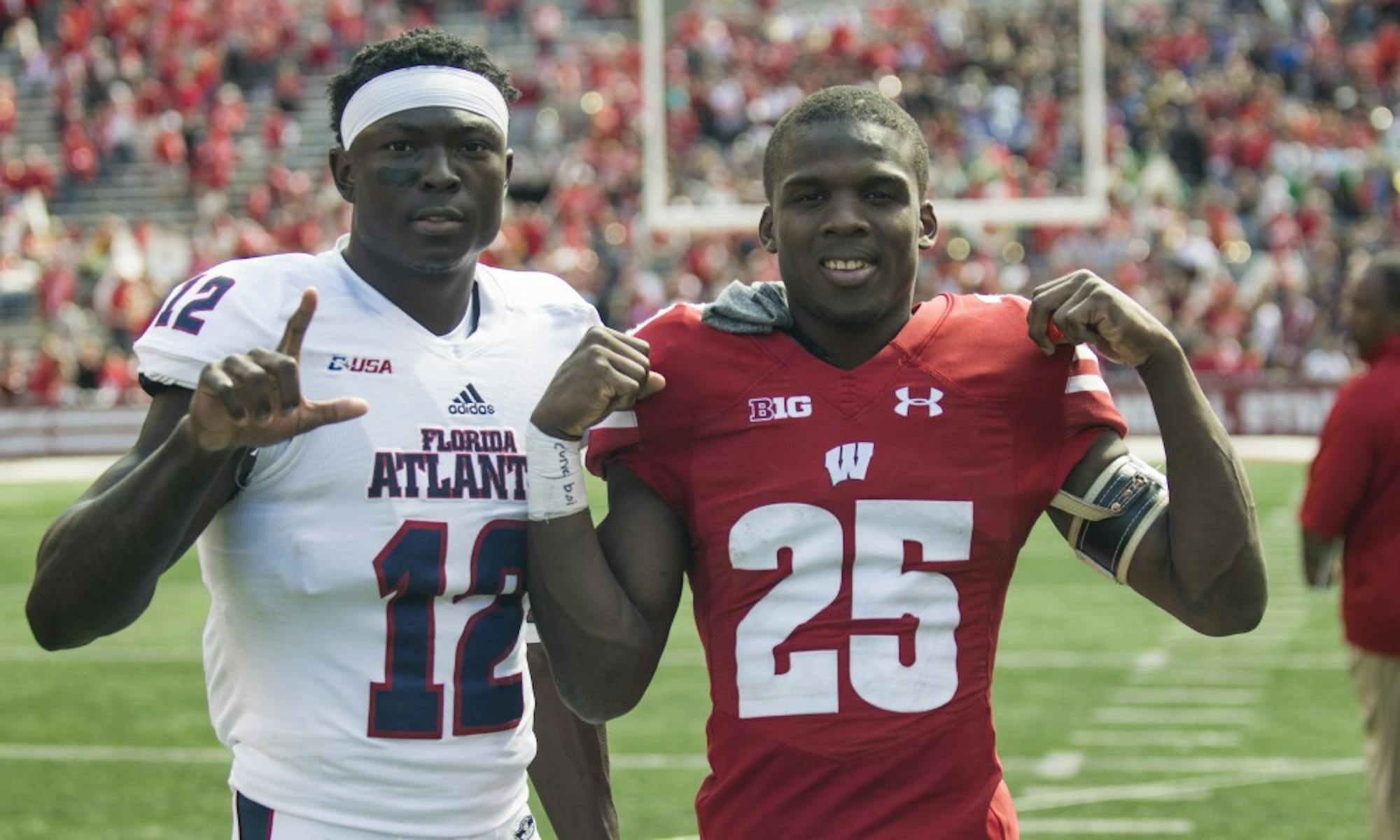 Derrick Tindal (right) poses with John Franklin III (left) after Wisconsin's 31-14 win over Florida Atlantic in early September. Both players are from Fort Lauderdale, Fla.&nbsp;