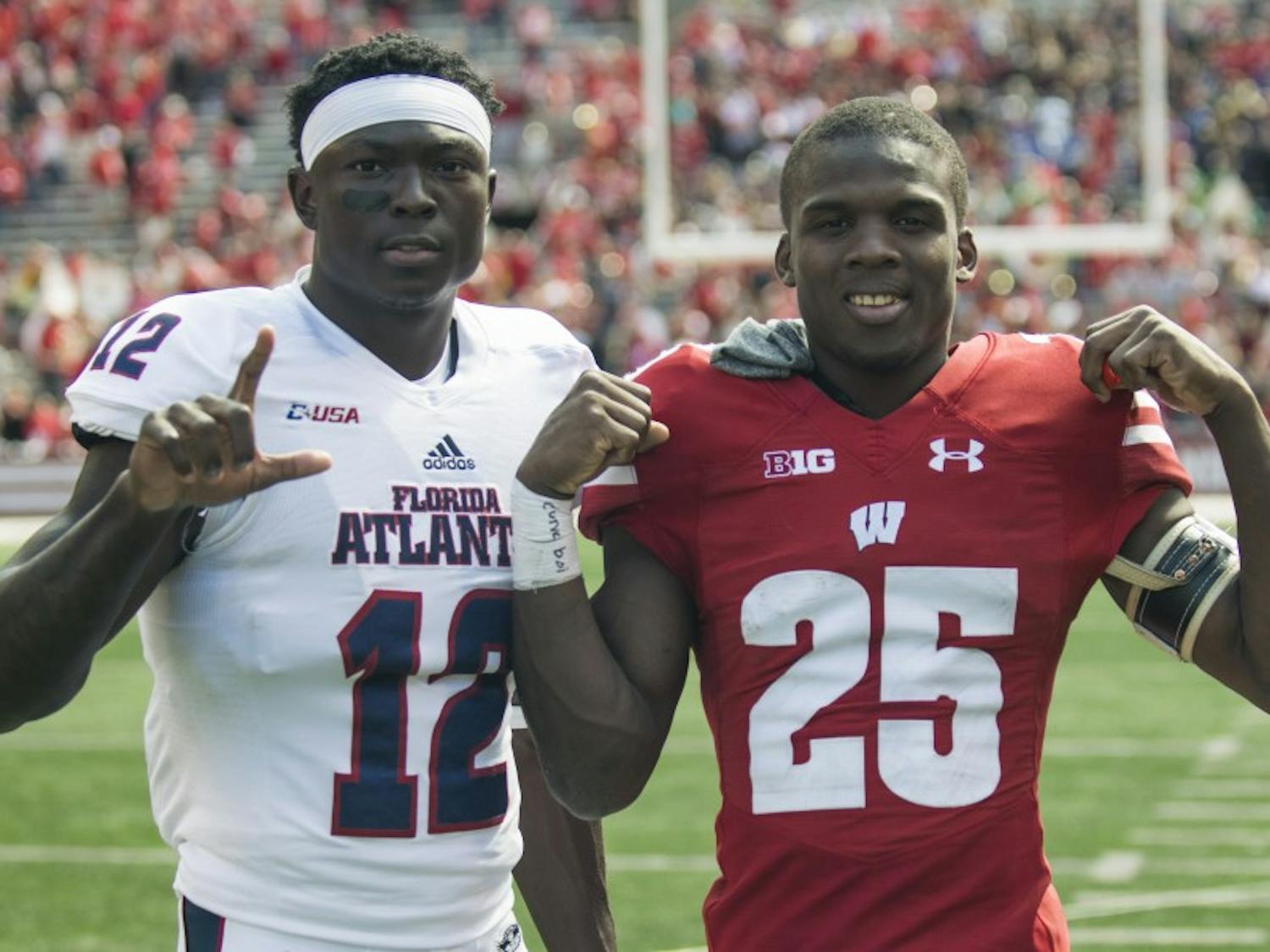 Derrick Tindal (right) poses with John Franklin III (left) after Wisconsin's 31-14 win over Florida Atlantic in early September. Both players are from Fort Lauderdale, Fla.&nbsp;